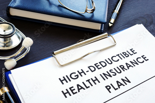 High-deductible health insurance plan HDHP on a desk. photo