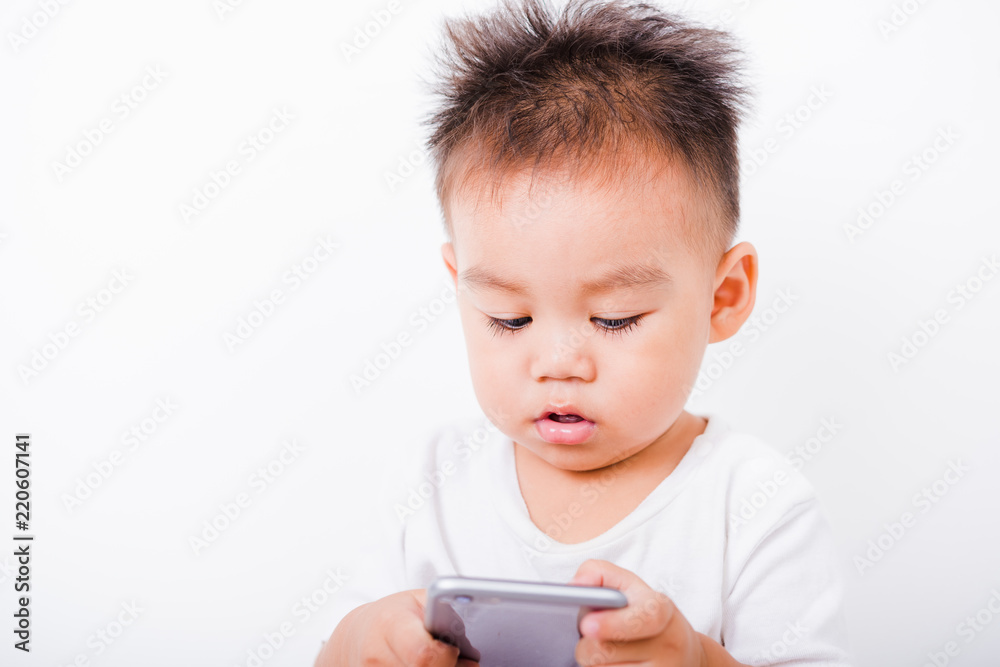 Asian portrait child boys 1 year 6 months holding smartphone Asian portrait child boys 1 year 6 months holding smartphone