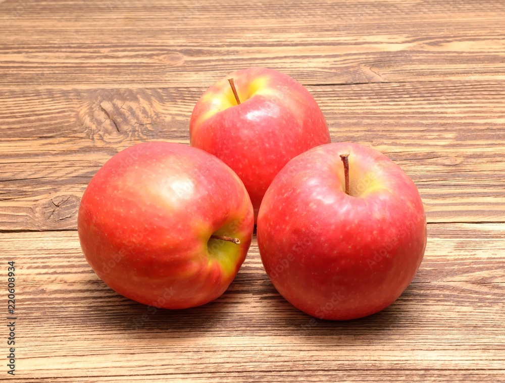 Pink Lady apples isolated on wooden background Pink Lady apples isolated on wooden background