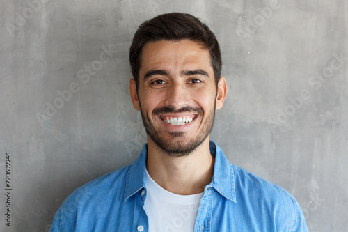 Young happy european caucasian man laughing positively and friendly photo