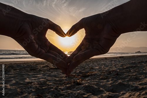heart with hands at sunset