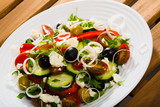 Balkan cuisine salad with fresh vegetables, brynza cheese and onion