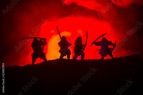 Silhouette of two samurais in duel. Picture with two samurais and sunset sky