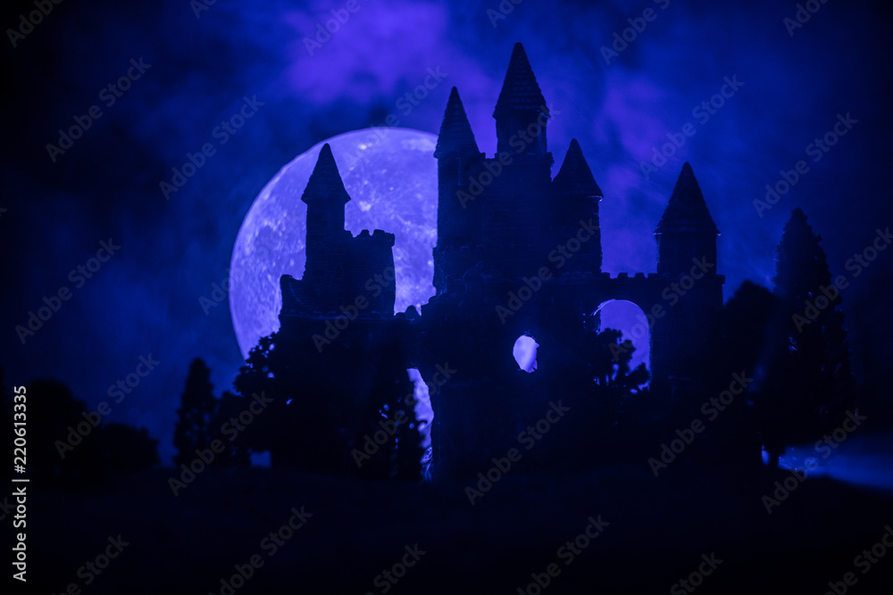 Obraz premium Mysterious medieval castle in a misty full moon. Abandoned gothic style old castle at night