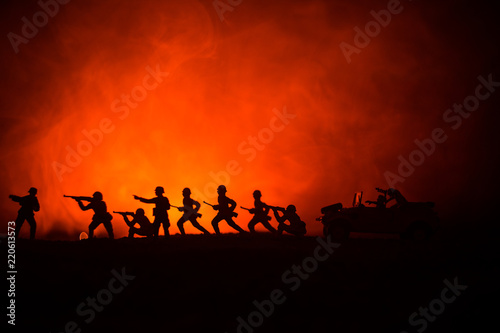War Concept. Military silhouettes fighting scene on war fog sky background  World War German Tanks Silhouettes Below Cloudy Skyline At night. Attack scene. Armored vehicles.