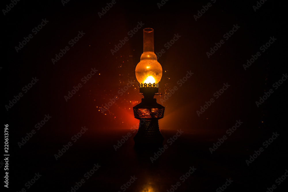 Oil Lamp Lighting up the Darkness or Burning kerosene lamp background, concept lighting. Selective focus Oil Lamp Lighting up the Darkness or Burning kerosene lamp background, concept lighting. Selective focus