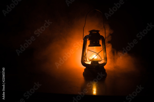 Oil Lamp Lighting up the Darkness or Burning kerosene lamp background, concept lighting. Selective focus photo