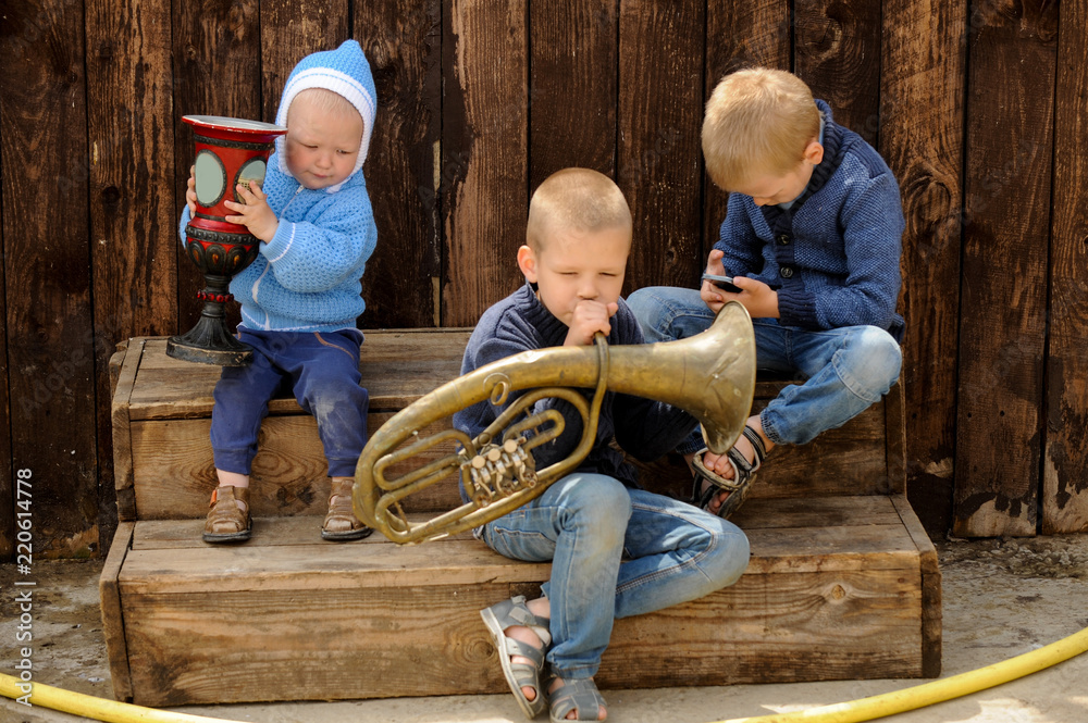Caucasian boys from the orphanage play with a high-pressure sink and try to wash a toy car. Caucasian boys from the orphanage play with a high-pressure sink and try to wash a toy car.