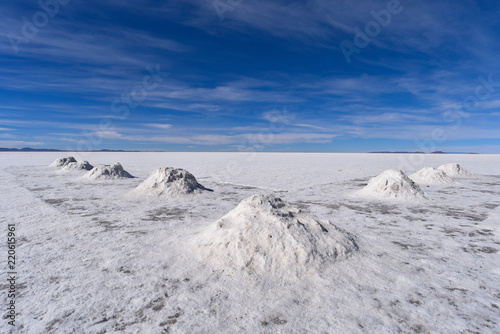 Piles of salt drying in the sun near the mining town of Colcani. Salar de Uyuni, the worlds largest salt flats, Bolivia