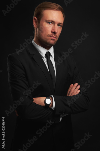 Confident handsome man in black suit