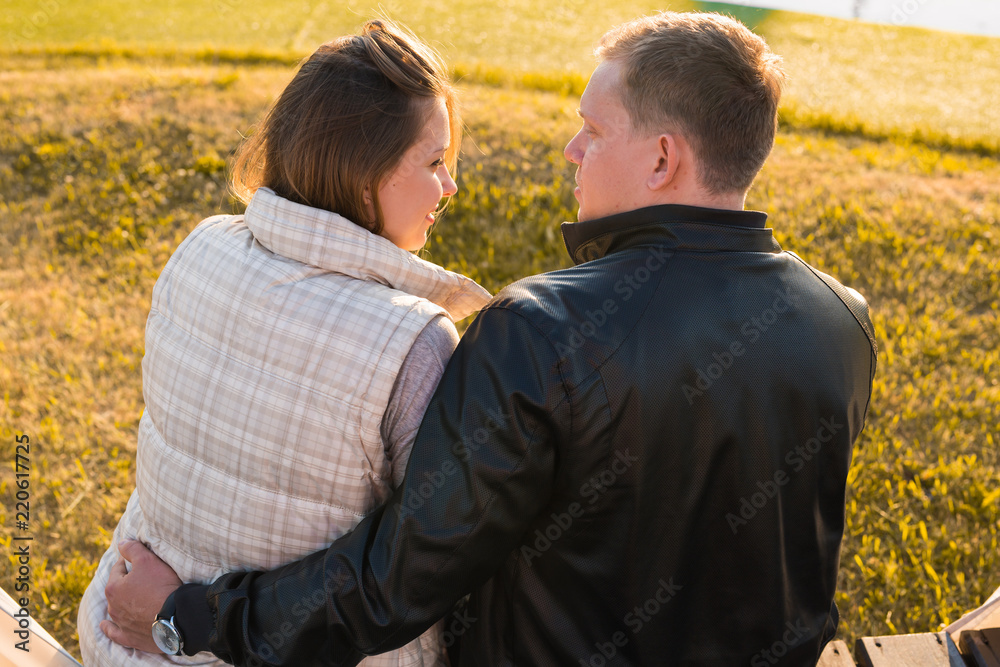 People, relations and feelings concept - young couple in love hugging in autumn park People, relations and feelings concept - young couple in love hugging in autumn park