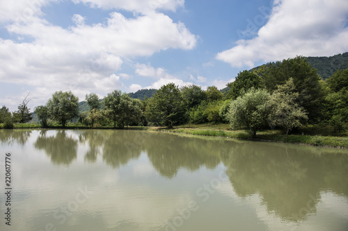 Landscape with misty morning fog in the Forest Lake or Beautiful forest lake in the morning at winter time. Azerbaijan nature. Caucasus.