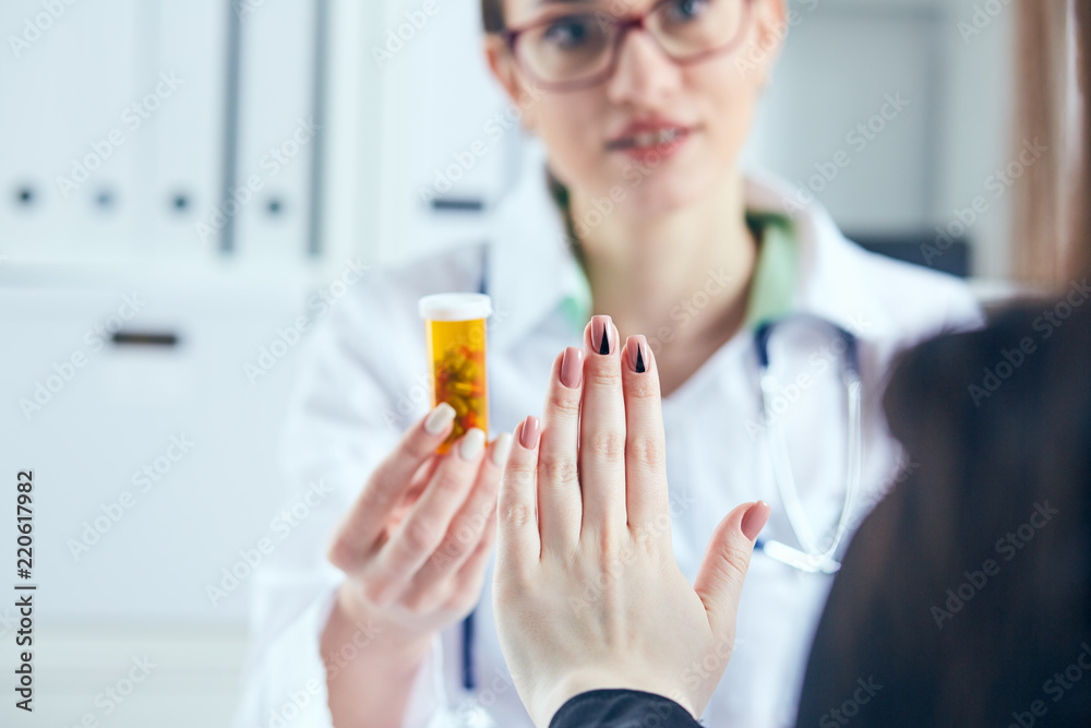 Female patient at the doctor appointment refuses to take prescribed medications, believes that they are useless and these biological drugs will only cause harm to his body. Female patient at the doctor appointment refuses to take prescribed medications, believes that they are useless and these biological drugs will only cause harm to his body.