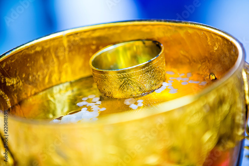 Holy water in golden bowl for buddhist worship in traditional ceremony as wedding ceremony and songkran festival. image for background, wallpaper, objects, copy space,article and illustration.