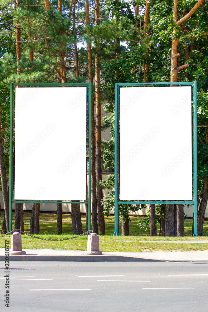 Mock up of two blank billboard, outdoors advertising boards in the city park Mock up of two blank billboard, outdoors advertising boards in the city park