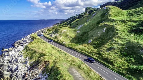 Northern Ireland, UK. Causeway Coastal Route a.k.a Antrim Coast Road. One of the most scenic coastal roads in Europe. Aerial 4K revealing video