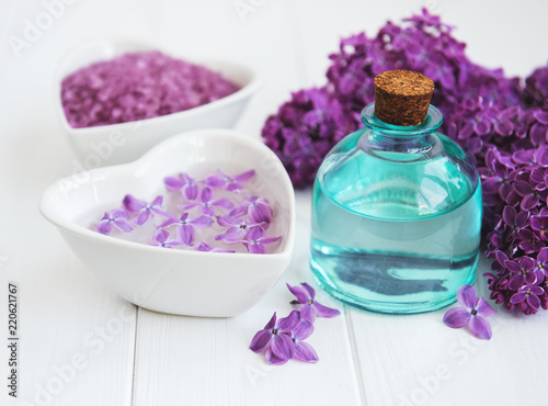 Essential oil and sea salt with lilac flowers