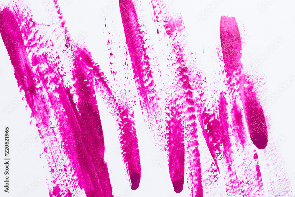 Nail polish on a white background in the form of strips and drops