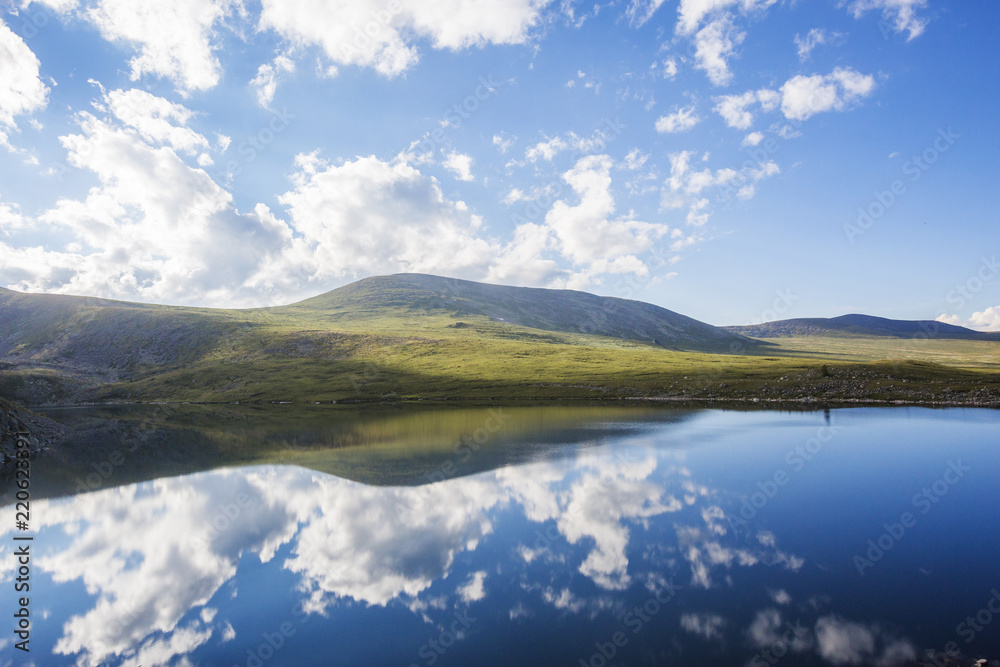 Reflection in water of Kyrgyz lake. Altai Mountains landscape Reflection in water of Kyrgyz lake. Altai Mountains landscape