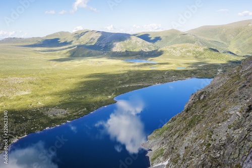 Reflection in water of Kyrgyz lake. Altai Mountains landscape