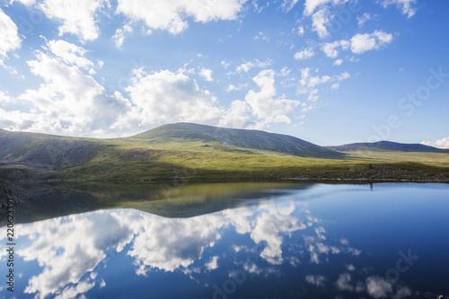 Reflection in water of Kyrgyz lake. Altai Mountains landscape