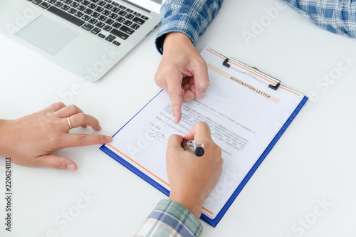 Canvas-taulu Woman employee writing a letter of resignation on the white table