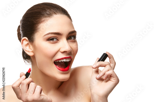 girl applying red lipstick isolated on white