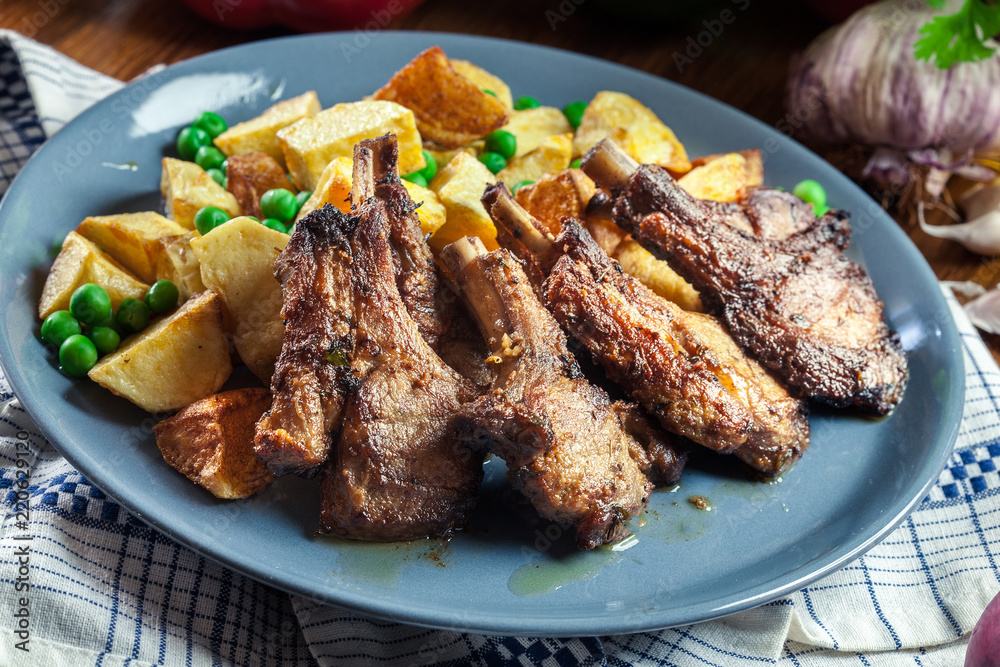 Roasted lamb chops served with baked potatoes