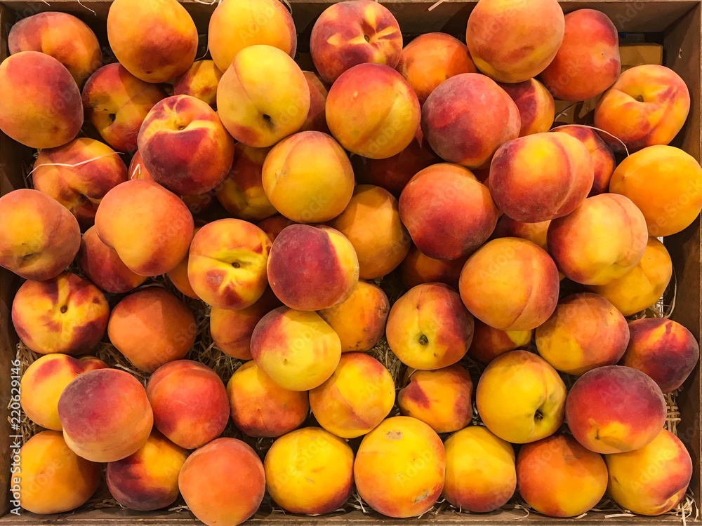 Peaches and nectarines on the counter for sale in a grocery shop. Peaches and nectarines on the counter for sale in a grocery shop.