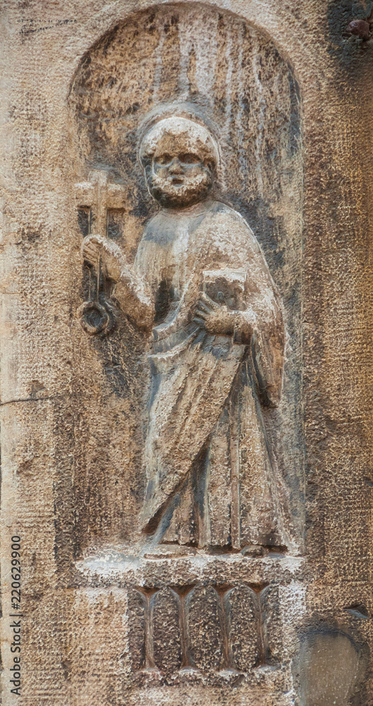 Saint Peter holding the Key of Heaven and the Bible, an ancient medieval relief on a wall in the historic center of Venice Saint Peter holding the Key of Heaven and the Bible, an ancient medieval relief on a wall in the historic center of Venice