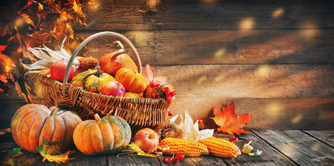 Thanksgiving pumpkins with fruits and falling leaves
