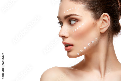 girl applying foundation on face isolated on white