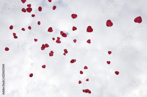 Flying red heart shaped ballons by jziprian photo