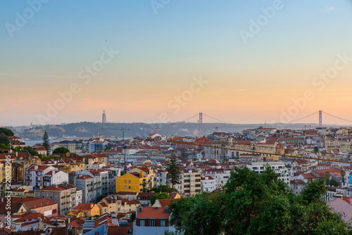 Lisbon  Portugal old town skyline with view on river Tagus and bridge on sunset