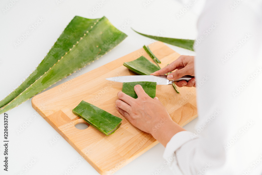 Woman preparing an aloe vera gel recipe with essences. Healthy, natural and cosmetic concept Woman preparing an aloe vera gel recipe with essences. Healthy, natural and cosmetic concept
