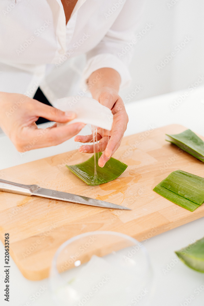 Woman preparing an aloe vera gel recipe with essences. Healthy, natural and cosmetic concept Woman preparing an aloe vera gel recipe with essences. Healthy, natural and cosmetic concept