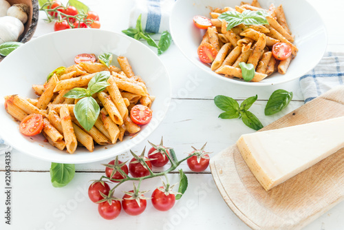 Penne pasta in tomato sauce with basil