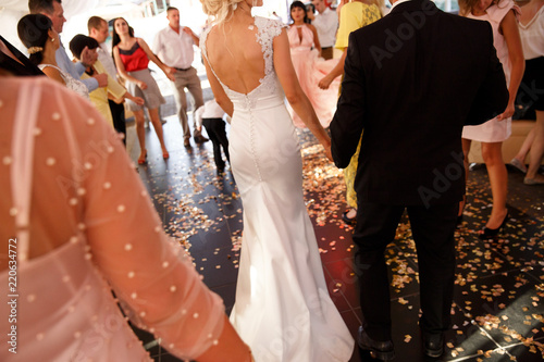 Slika na platnu Wedding couple, bride and groom with guests on wedding party