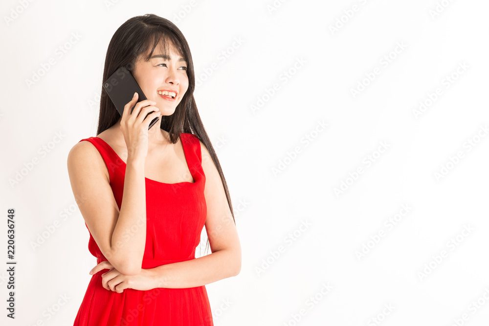 Beautiful Attractive Asian young woman with black hair wearing red dress talking in smartphone and smile feeling so happiness and cheerful,Isolated on white background,Business Startup Concept Beautiful Attractive Asian young woman with black hair wearing red dress talking in smartphone and smile feeling so happiness and cheerful,Isolated on white background,Business Startup Concept