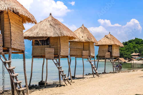 Row of Tiki Huts Sunny Beach Vacation Ocean Tropical Living