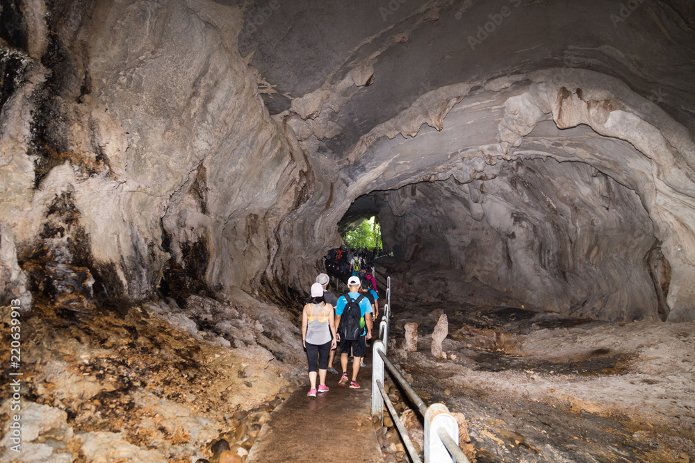 Tourists walking within path inside Wind Cave, Mulu National Park