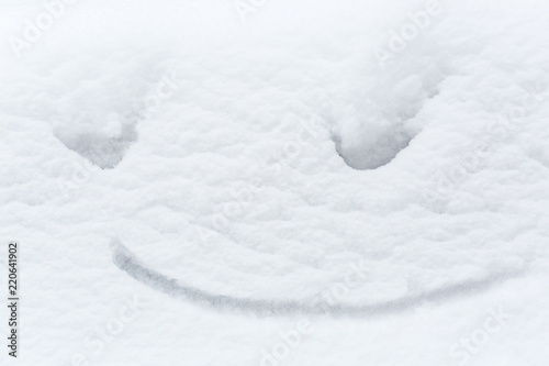 Snow funny background with a cheerful smile, symbol of winter, happy image.