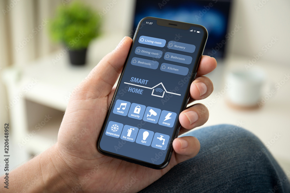 man hand holding phone with app smart home in room man hand holding phone with app smart home in room