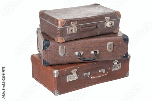 three old vintage suitcases of different size, isolated on white background