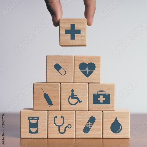Concept of Insurance for your health, Hand hold wooden block with icon healthcare medical