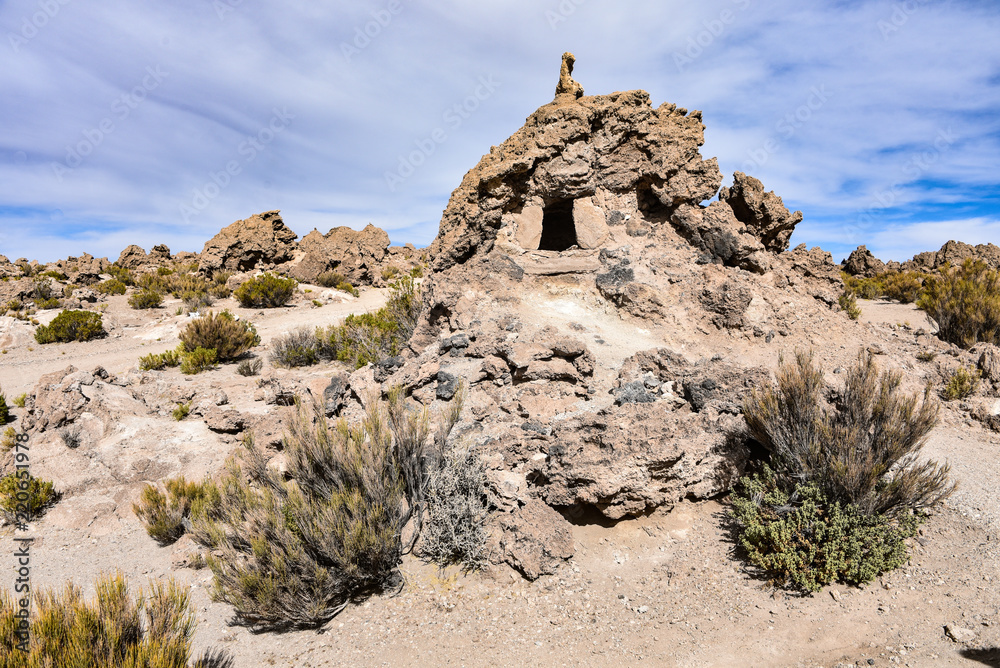 Fototapeta premium Ancient human remains buried in traditional Chullpas at the Necropolis of San Juan