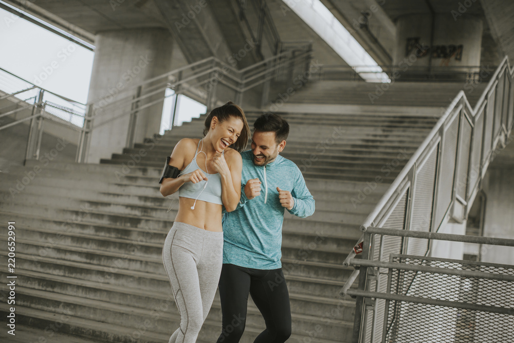 Young couple running in urban enviroment