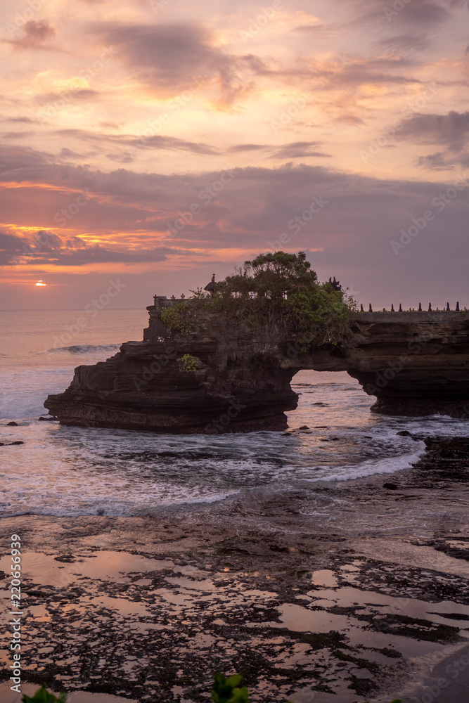 Sunset at Pura Batu Bolong temple on the beatiful rock in Bali