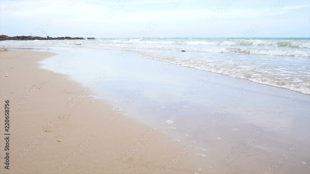 Slow motion scenic landscape of nature sea wave coast to beach with stone and rock for summer vacation concept Slow motion scenic landscape of nature sea wave coast to beach with stone and rock for summer vacation concept