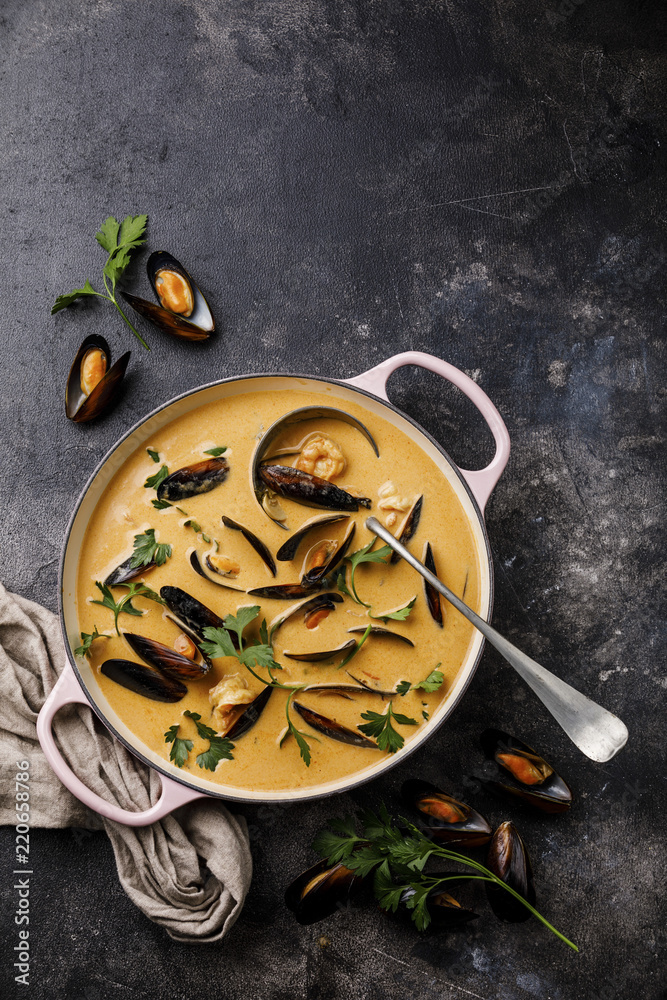 Seafood soup with shrimp and mussel in casserole on dark background copy space Seafood soup with shrimp and mussel in casserole on dark background copy space